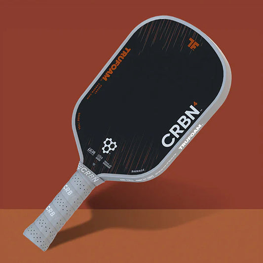 Black pickleball paddle with white edge and grip, angled view from the side