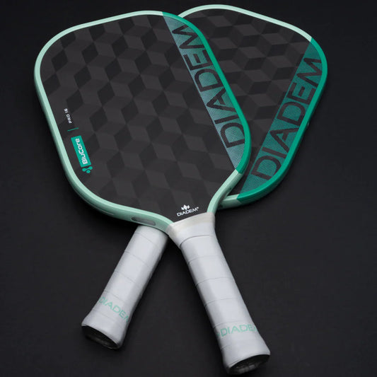 Pickleball paddle showing head and dual white grips, dark face with seafoam trim