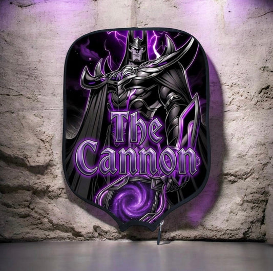 Purple and black pickleball paddle face with stylized “The Cannon” graphic