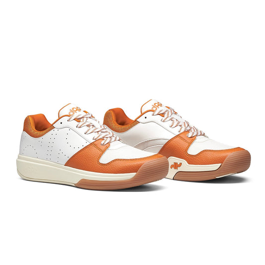 Pair of DAPS DESI women's low-top pickleball shoes, white with burnt orange, lace-up.