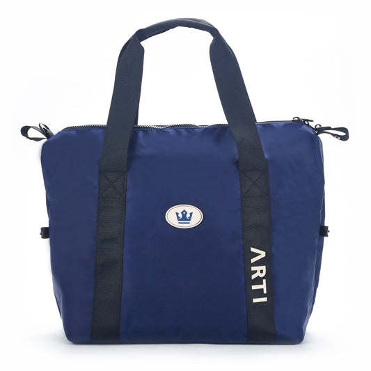 Navy duffle bag with black handles, zip top, and ARTI logo patch