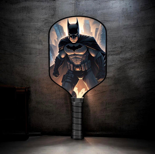 Batman-themed pickleball paddle with black grip and circular bat emblem face