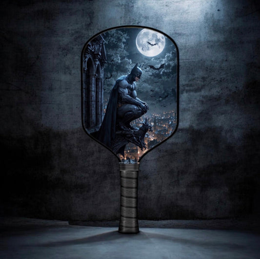 Batman-themed pickleball paddle with moonlit city graphic and textured handle