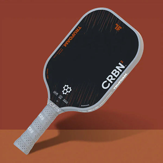 Pickleball paddle, black shield face with white edge and CRBN marking; white grip handle