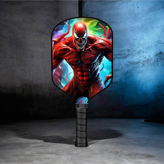 Pickleball paddle with bold red-and-green comic-style face graphic and black handle