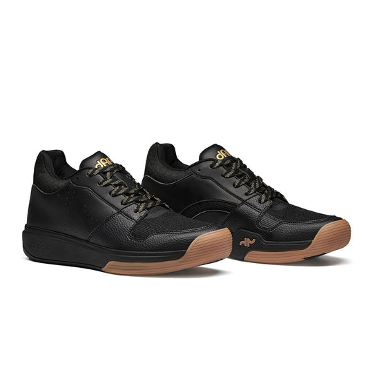 Pair of men's black mid pickleball shoes with lace-up uppers and gum rubber outsole
