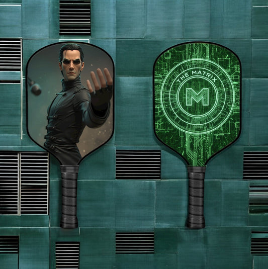 Pickleball paddle with dark face and neon green Matrix-style emblem, black grip
