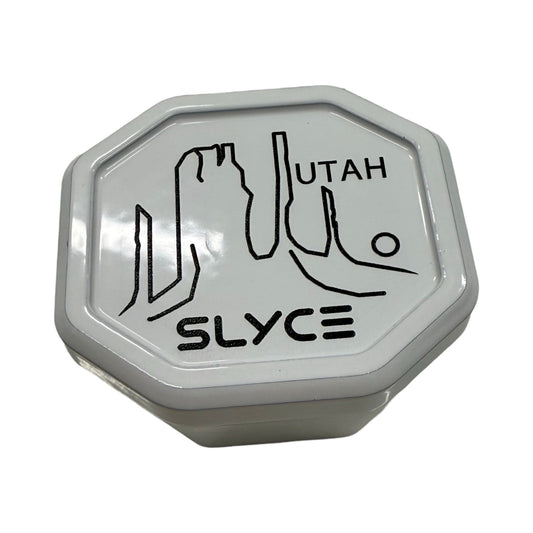Octagonal SpeedCap enhancer tin, gray with black UTAH SLICE logo.