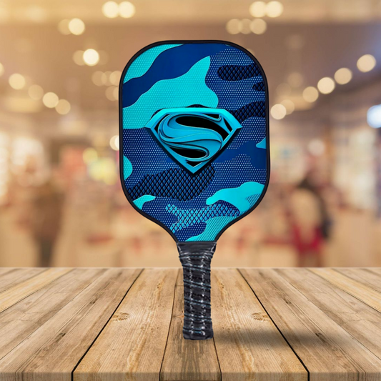 Blue camo pickleball paddle with Superman logo and textured racket face