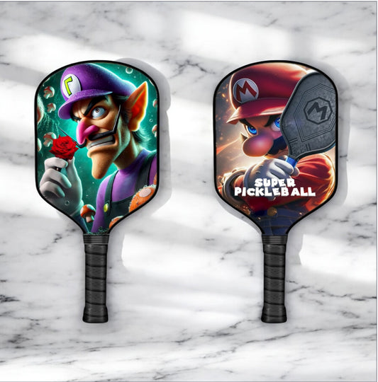 Pickleball paddle with colorful cartoon character graphic, dark textured grip