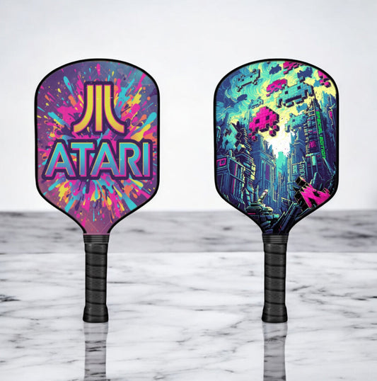 Space Invaders edition pickleball paddle with colorful ATARI graphic face, black handle
