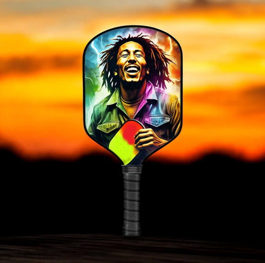 Pickleball paddle with colorful portrait artwork and black handle grip