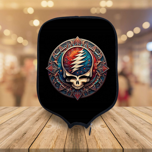 Black padded pickleball paddle cover with colorful skull emblem and zipper edge