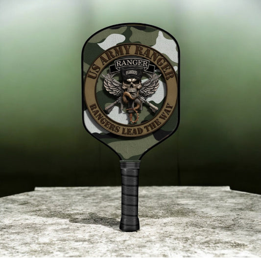 Camouflage pickleball paddle with skull eagle emblem and black grip.