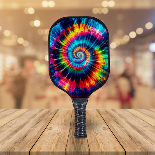 Neon tie-dye pickleball paddle with spiral multicolor graphic and textured black handle