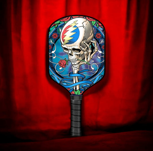Pickleball paddle with colorful skull-and-rose face and black handle grip