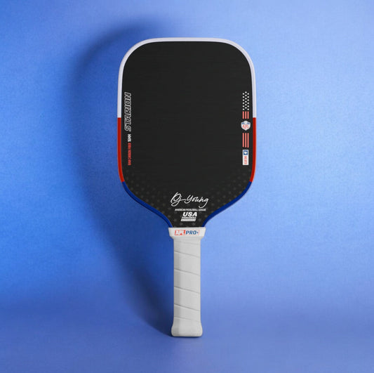 Black pickleball paddle face with blue edge trim and white extended grip handle
