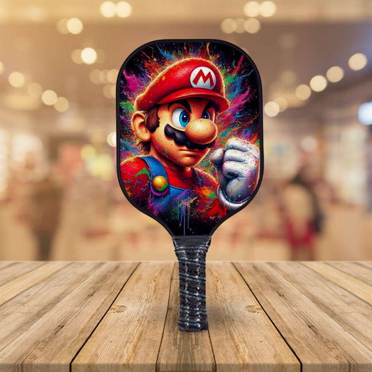 Pickleball paddle with colorful Mario splash face graphic and black ribbed grip
