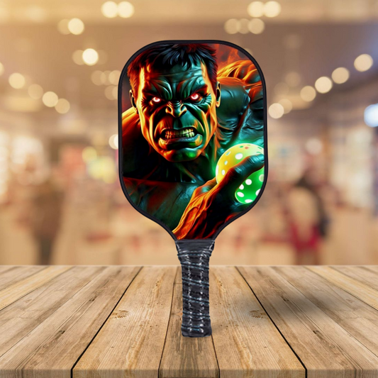 Pickleball paddle with fiery green and orange Hulk graphic face on paddle surface