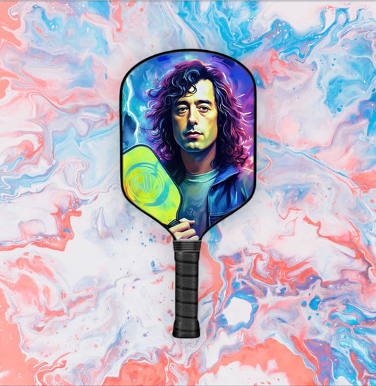 Pickleball paddle with black handle and circular face featuring a colorful portrait design