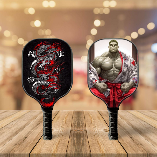Pickleball paddle set with red dragon graphic on dark face and matching red-and-white grip