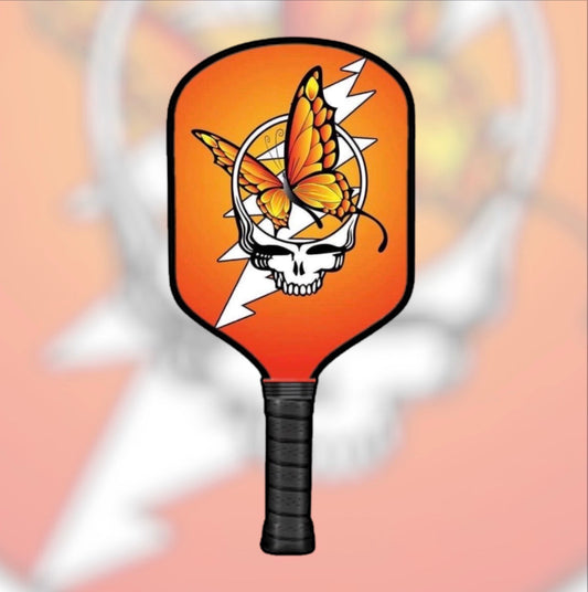 Pickleball paddle with orange head and stealie butterfly skull graphic, black grip