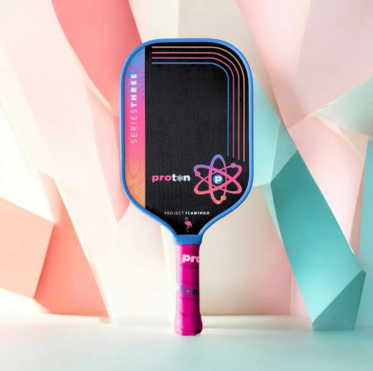 Elongated pickleball paddle in blue frame with black face and pink grip