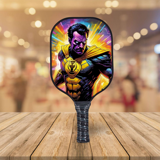 Comics-style pickleball paddle with purple and yellow character graphic on black face