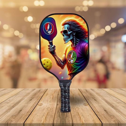 Pickleball paddle with colorful skull and skeleton artwork on a blue paddle face