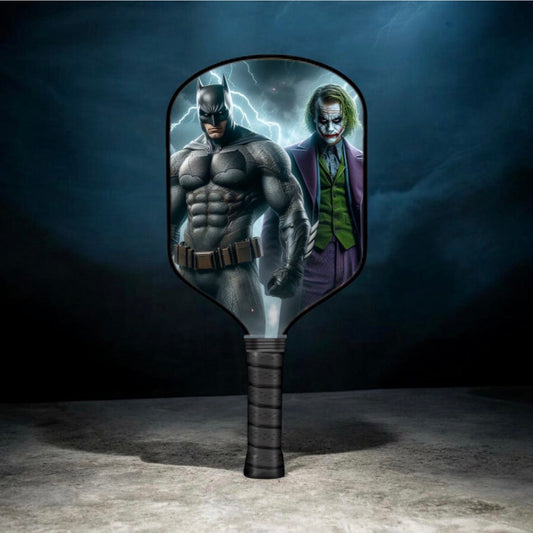 Themed pickleball paddle with oval head and dark grip, featuring Batman and Joker artwork