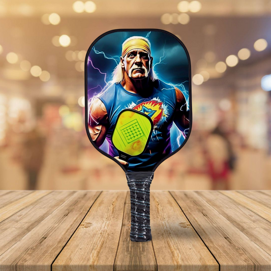 Blue pickleball paddle with multicolor character graphic and textured grip handle