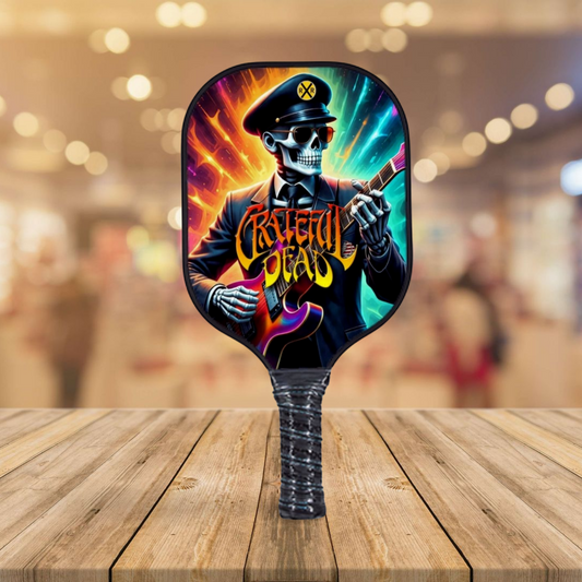 Pickleball paddle with colorful skeleton graphic and guitar on dark face