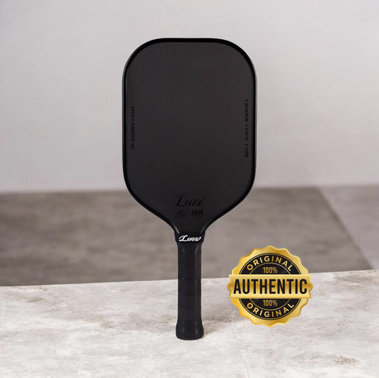 Black pickleball paddle with rounded teardrop head and textured grip handle