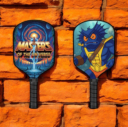 Pickleball paddles with blue character graphics and black rubber grip handles