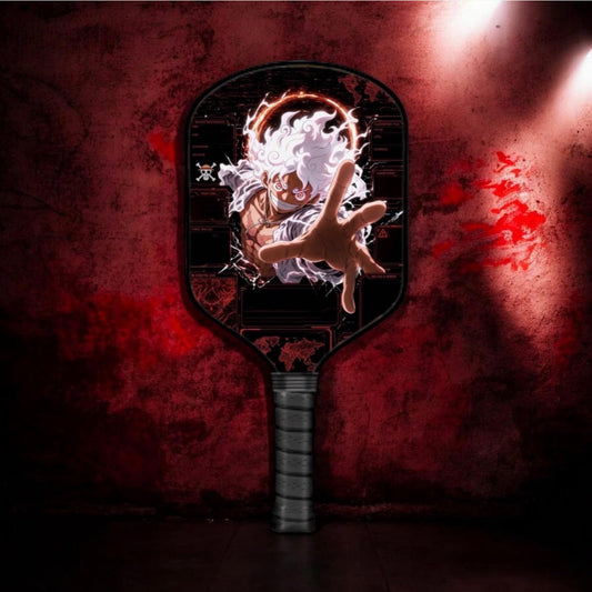 Pickleball paddle with black face, character graphic, and textured black grip handle