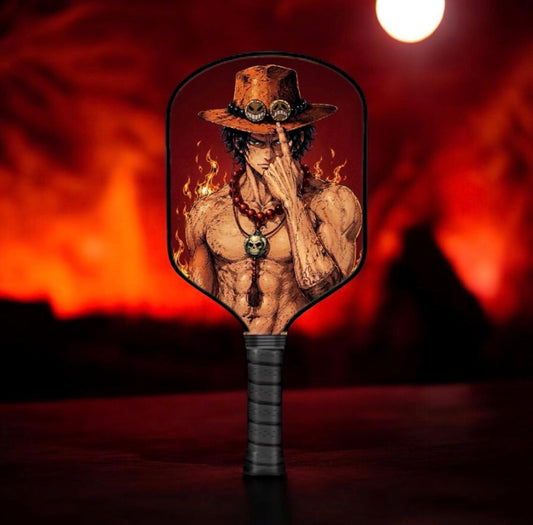 Pickleball paddle with black handle and fiery character graphic on the face