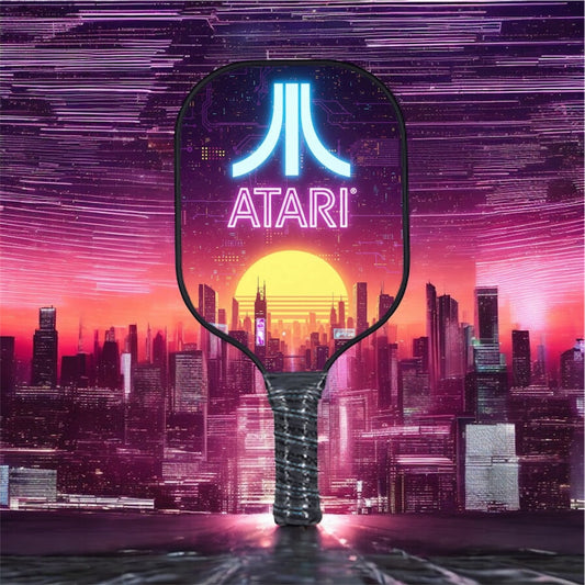 Neon Atari pickleball paddle with purple city graphic and textured black grip