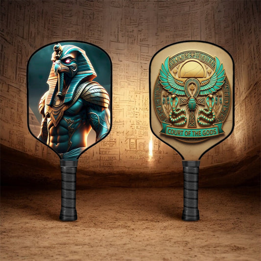 Horus-themed pickleball paddle with teal bird and gold body graphic on face