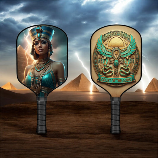 Pickleball paddle with blue Egyptian-style goddess art on one face and gold emblem on the other