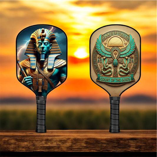 Pickleball paddle with Ptah-themed artwork on a black paddle face