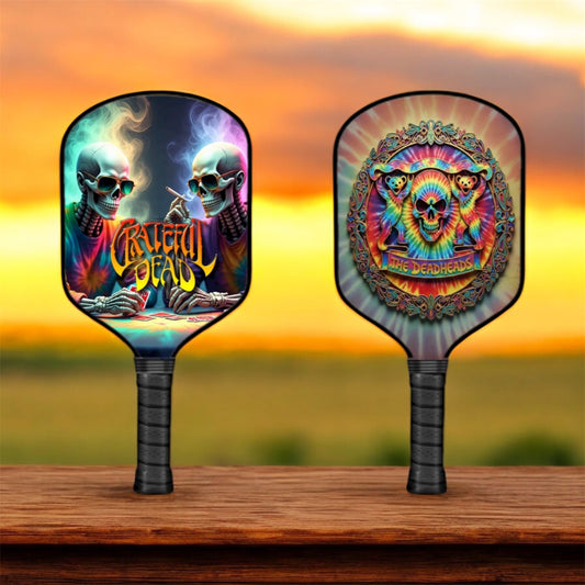 Pair of pickleball paddles with colorful skull graphics and black grips