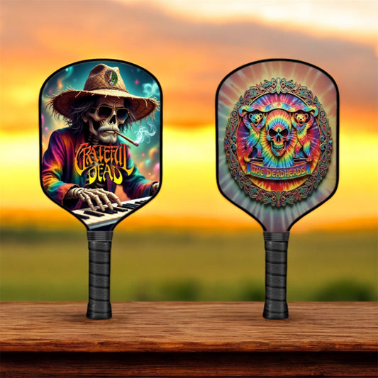 Pair of dark pickleball paddles with colorful skull graphic faces