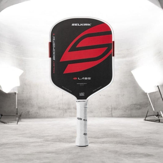 Red, black and white pickleball paddle with logo on the face