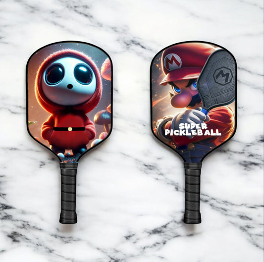 Shy Guy themed pickleball paddle with black grip and two-sided graphic faces