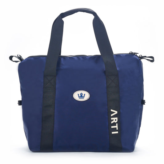 Navy duffle bag with black handles, zip top, and ARTI logo patch