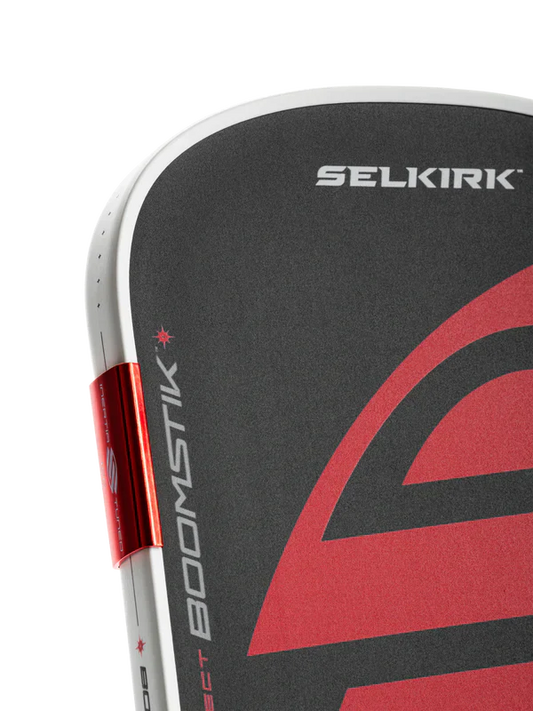 Black pickleball paddle face with red swoosh design and SELKIRK text
