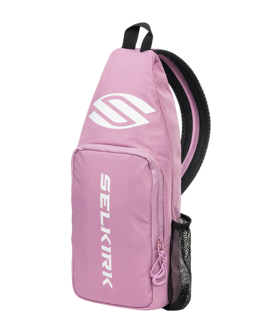 Selkirk pink sling bag with black straps, front zipper pocket and logo patch