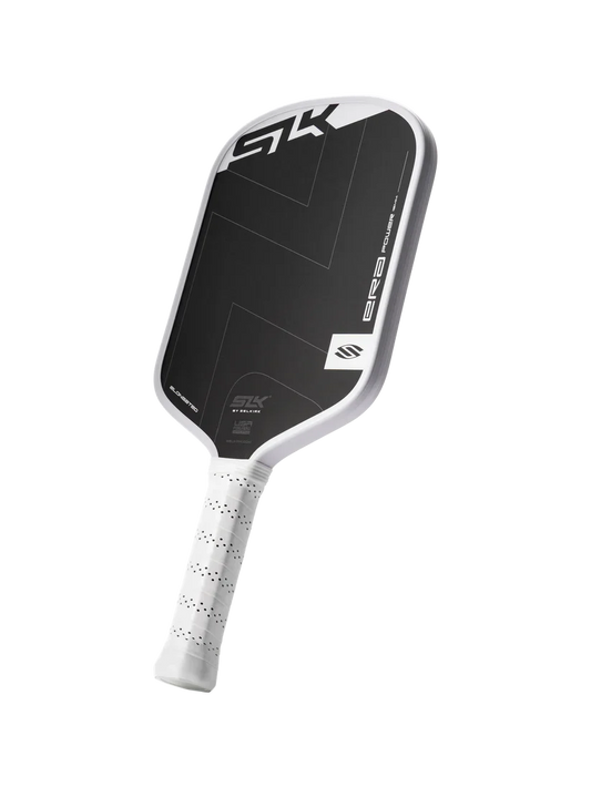 Elongated pickleball paddle with dark face and speckled white grip, angled view